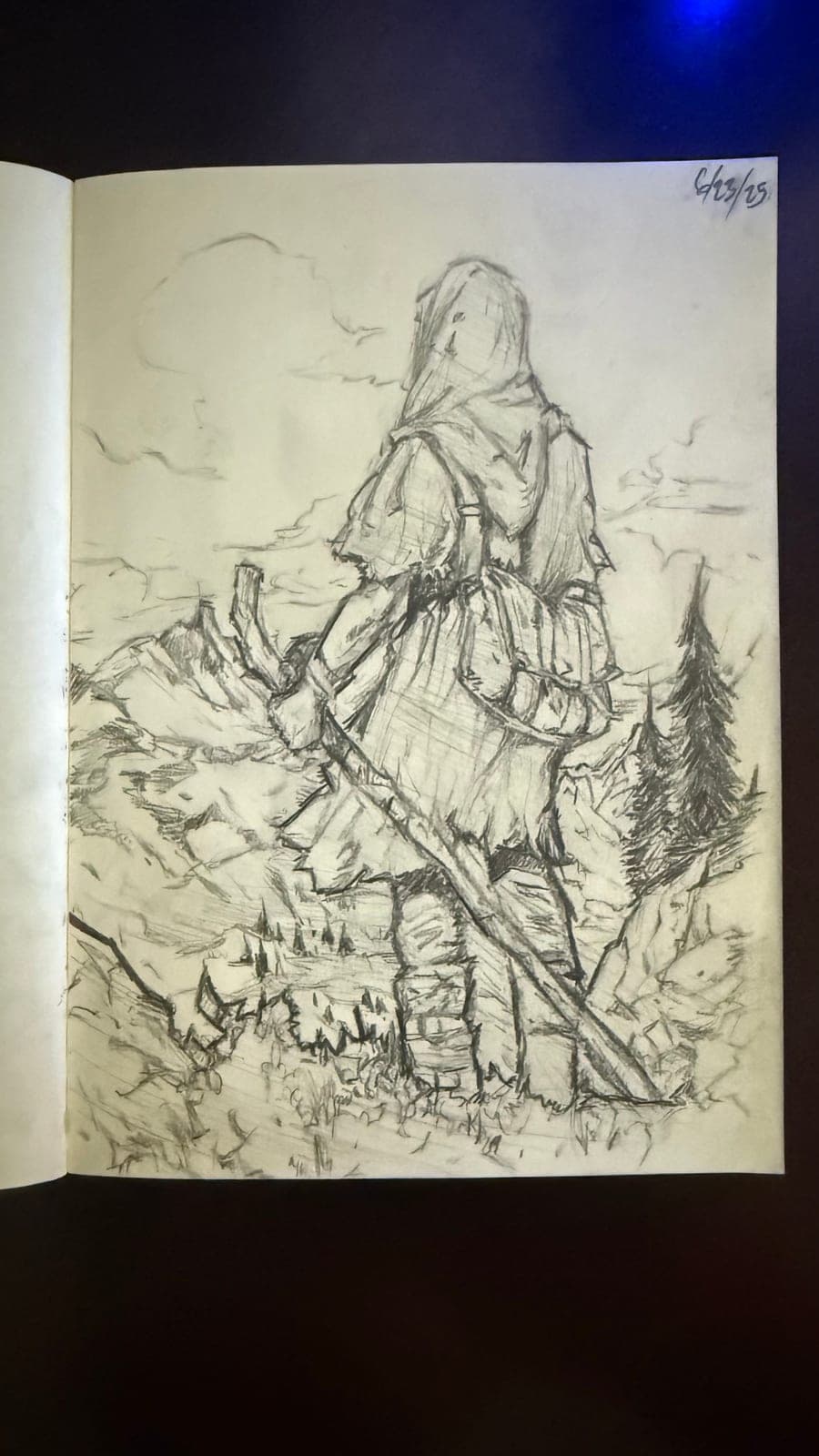 Pencil sketch in a sketchbook: a hooded traveller seen from behind, pack on their back and staff in hand, looking out over rocky hills and pines.